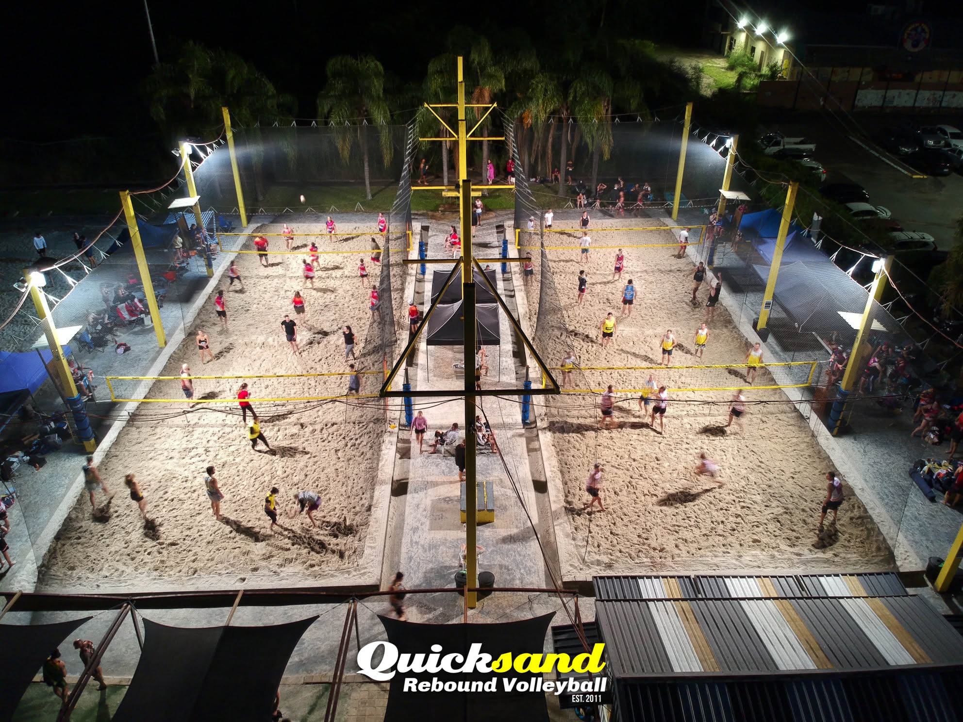 The former Quicksand venue lit up at night with four courts in play